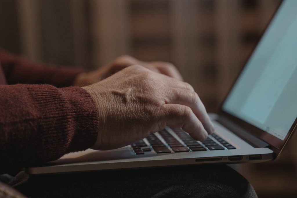 Email Security Explained Close-up of hands typing on a laptop keyboard, ideal for business and technology themes.