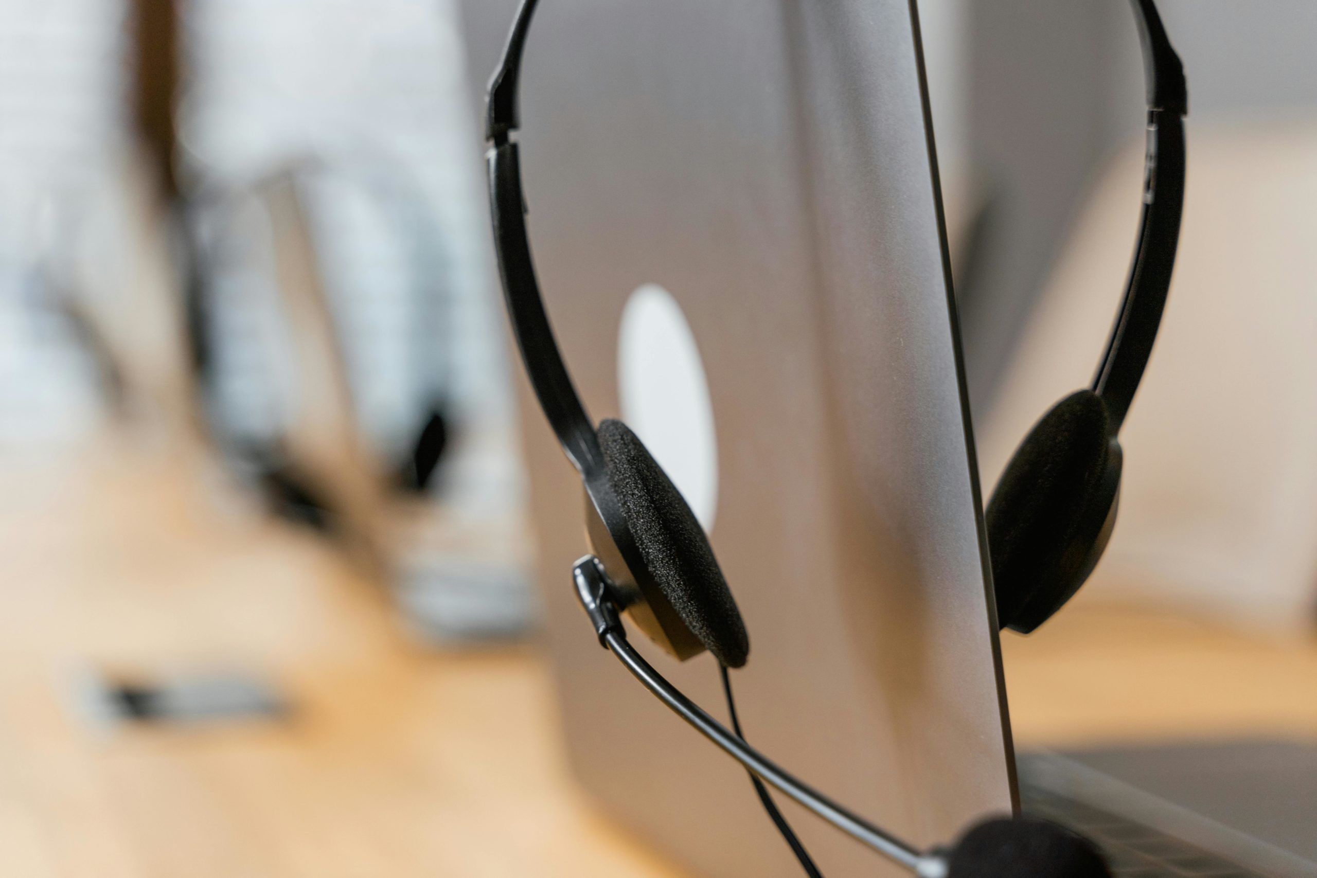 Close-up of a headset resting on a laptop, symbolizing efficient work environment technology.
